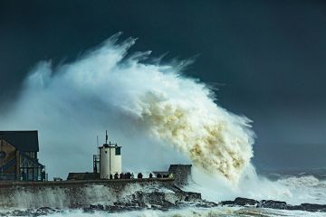 Huge wave crashes on pier