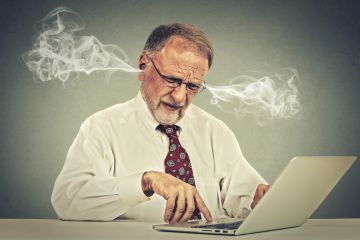 Stressed man at computer