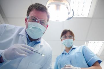 Student and dentist in dental surgery