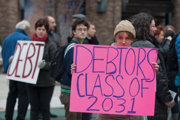 Student demonstrators holding 'Debtors class of 2031' sign Student demonstrators holding 'Debtors class of 2031' sign