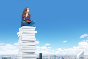 Student sitting high above city Student sitting high above city