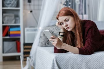 A student looking at her mobile phone