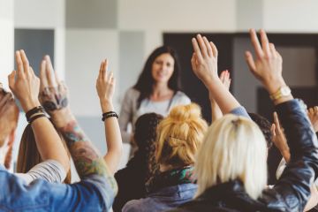 Students raising hands during lecture Students raising hands during lecture