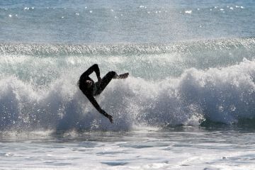 Surfer wiping out on wave, Mojácar, spain Surfer wiping out on wave, Mojácar, spain