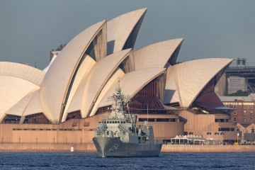 Sydney, Australia - October 5, 2013 HMAS Parramatta (FFH 154) Anzac-class frigate of the Royal Australian Navy in Sydney Harbor with the Sydney Opera House in the background.