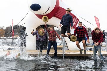 Participants jump into the water during the Minnesota Polar Plunge to illustrate Teach for America at turning point as numbers participating drop off 