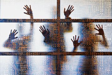 People outlined behind a screen showing computer circuitry