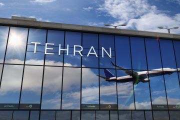 A plane reflected in the glass of Tehran airport