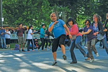 Members of the public perform the Conga dance