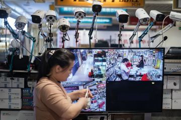 shopper surrounded by surveillance cameras