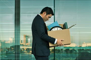 Fired man carrying box