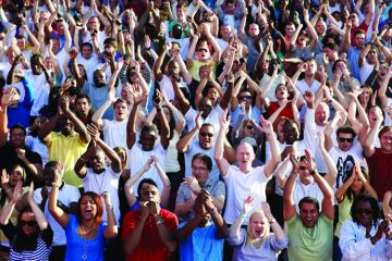 Crowd of people clapping and cheering