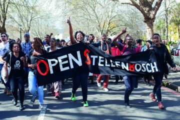 A group of students shout slogans and hold banners at Stellenbosch University in Cape Town, South Africa A group of students shout slogans and hold banners at Stellenbosch University in Cape Town, South Africa