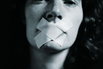 Woman with tape over her mouth