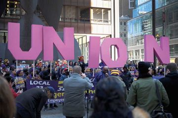 Members of the Service Employees International Union hold a rally in support of the American Federation of State County and Municipal Employees union