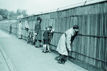 People looking through a fence
