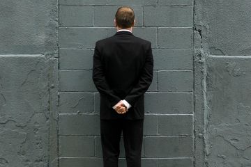 Man in front of brick wall