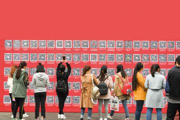 Students in China take pictures of QR codes at a jobs fair