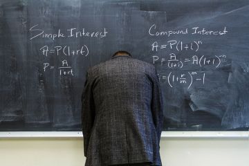 A teacher turned to face the blackboard A teacher turned to face the blackboard