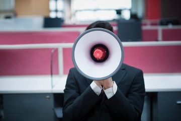 A person obscured by a megaphone