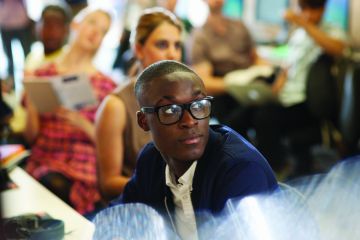 Male university student listening to seminar
