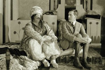 Man looking uncomfortable as woman looks at him