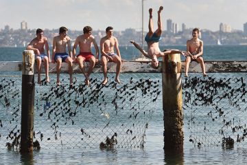 Children play on a shark net at Little Manly Cove, Australia