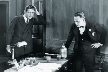Two men looking surprised in an office
