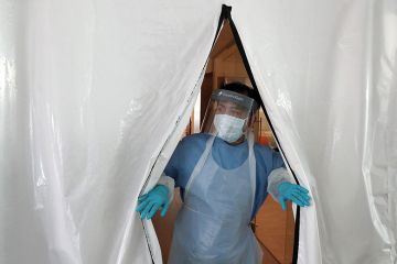 A laboratory technician wearing full PPE (personal protective equipment) works at a new Lighthouse Lab facility dedicated to testing for the novel coronavirus COVID-19, at Queen Elizabeth University Hospital in Glasgow on April 22, 2020.