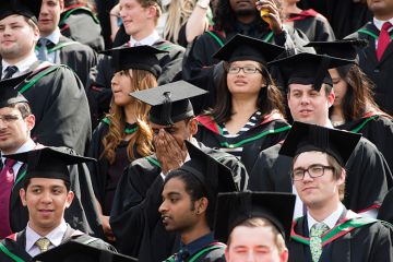 Graduating students in mortarboards