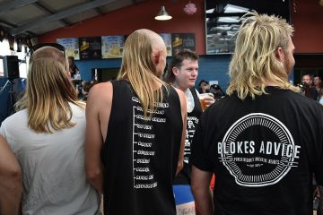 Men wait to be judged on their mullet hairstyles at Mulletfest 2018 in the town of Kurri Kurri, 150 kms north of Sydney, Australia