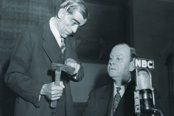 Man showing axe to another