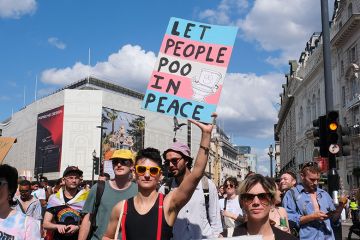 Person holding a sign stating “let us poo in peace” during the Trans Pride march in London, 2024. To illustrate that more UK universities will have to implement policies that restrict the facilities trans people can use after a Supreme Court ruling. Person holding a sign stating “let us poo in peace” during the Trans Pride march in London, 2024. To illustrate that more UK universities will have to implement policies that restrict the facilities trans people can use after a Supreme Court ruling.