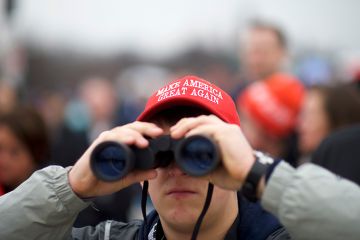 A Trump supporter wearing a MAGA hat looks towards the U.S. Capitol Building with binoculars during the inauguration of Donald Trump. To illustrate fears that Trump-backed overseers ‘will block scientific progress’ A Trump supporter wearing a MAGA hat looks towards the U.S. Capitol Building with binoculars during the inauguration of Donald Trump. To illustrate fears that Trump-backed overseers ‘will block scientific progress’