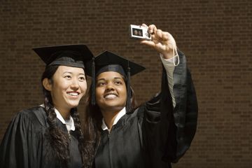 Two female graduates taking a photograph