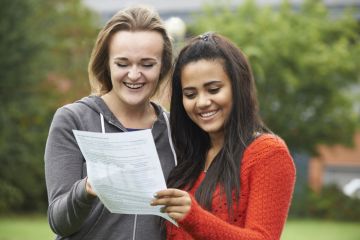 Two Female Students Celebrating Exam Results Together