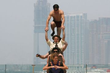 Circus Oz from Australia try to balance on each other to illustrate Overseas earnings do not balance books, Australian v-cs say