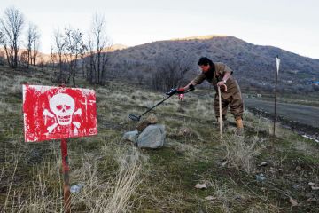 Person walks in a minefield trying to deactivate the devices on the outskirts of the Kurdish town of Halabja, Iraq as a metaphor for ‘Tech without humanities leads to problems’