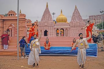 Artists perform in front of a replica of Kashi Vishwanath Dham Corridor to illustrate India’s fake universities proliferate as demand outstrips supply