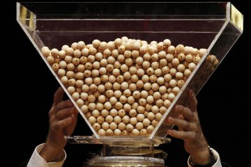 Lottery balls are dropped into a rotating drum before the start to illustrate Netherlands plots cautious return to degree admission lotteries