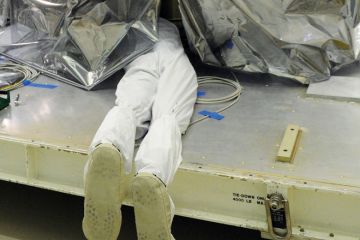 Person underneath a plastic sheet to illustrate Florida university leaders silent as DeSantis rages