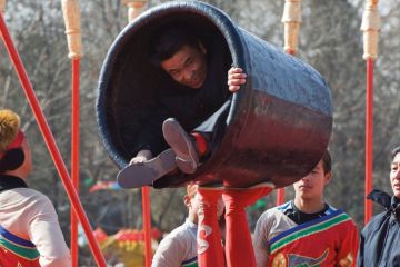 Person in a small container during a performance in China Beijing to illustrate Universities ‘in tricky position’ on Chinese student contracts