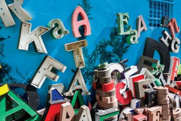 Giant letters scattered and stacked up along a building to illustrate Sloppy writing, sloppy science