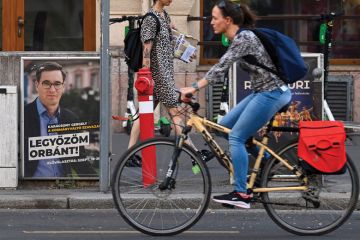 A cyclist drives past a campaign poster of the Budapest Mayor and candidate for prime minister Gergely Karacsony  'Parbeszed Magyarorszagert' (Dialogue for Hungary) reading 'I will defeat (Hungarian Prime Minister) to illustrate Hungarian election brings 