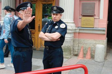 Security officers stand guard outside the US Consulate in Saint Petersburg