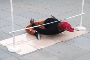Person very low on ground under a limbo to illustrate the University of Liverpool against making redundancies based on research grant income and citation impact scores.
