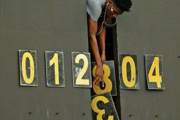 Scoreboard operator dropping numbers as a metaphor for University ‘fudging figures’ on sociology cuts