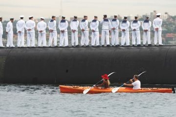 Sailors stand in line with a boat going behind them as a metaphor for Defence research ‘antidote’ to Covid’s lost billions: thinktank
