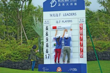 Scorers make a change on a scoreboard in Hainan Island, China to illustrate ‘Up-or-out’ systems heap pressure on junior academics in China