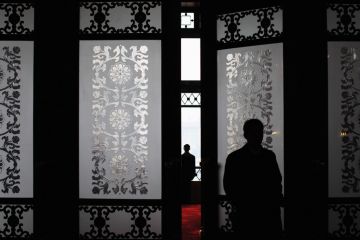A security officer stands guard at the main entrance of the Great Hall of the People in Beijing, China to illustrate fears grow over missing academics